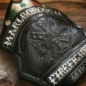 A hard-carved and hand-painted fire helmet shield by Smoked Leather.